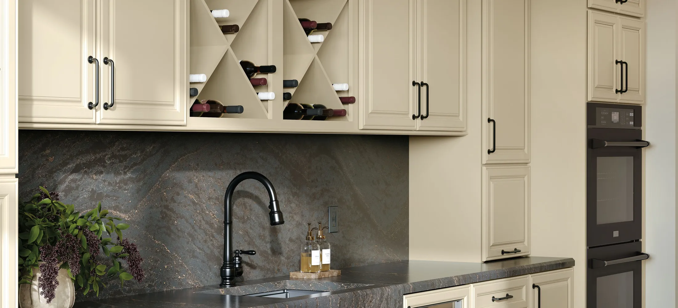 Kemper painted cabinetry with dark stone counters and a built-in wine rack
