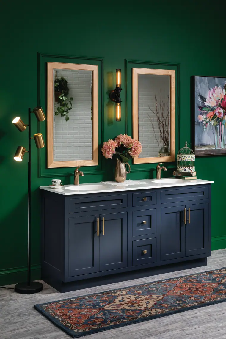 Bold powder room with a navy vanity against an emerald-green wall