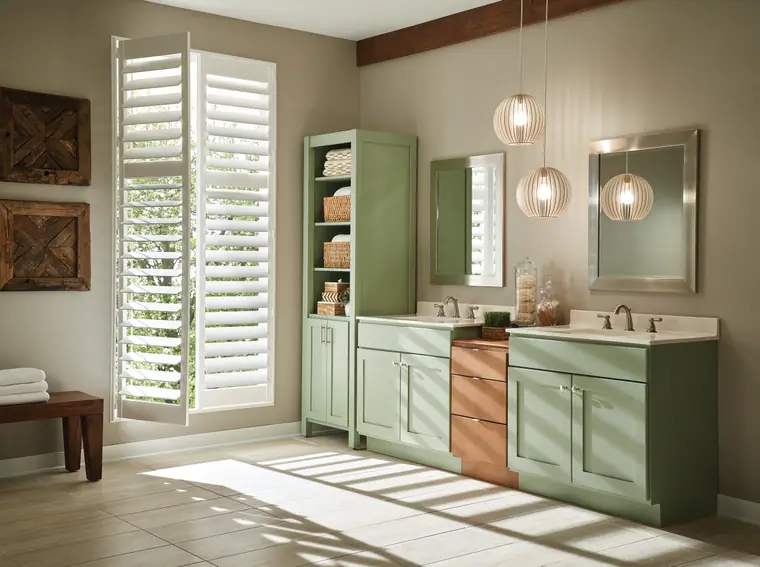 Sage-green and natural-wood double vanity in a bright bath