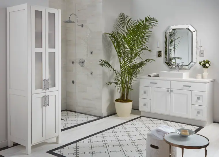 Bright white spa bathroom with a glass walk-in shower and marble tile