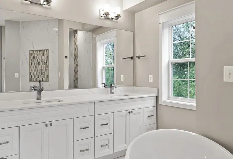 White Fabuwood double vanity in a bright bathroom