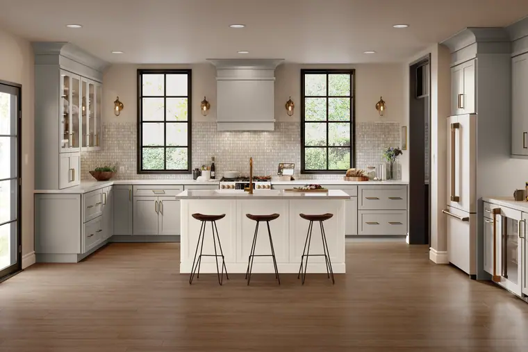 Greige kitchen with a brass faucet, black windows, and a large island