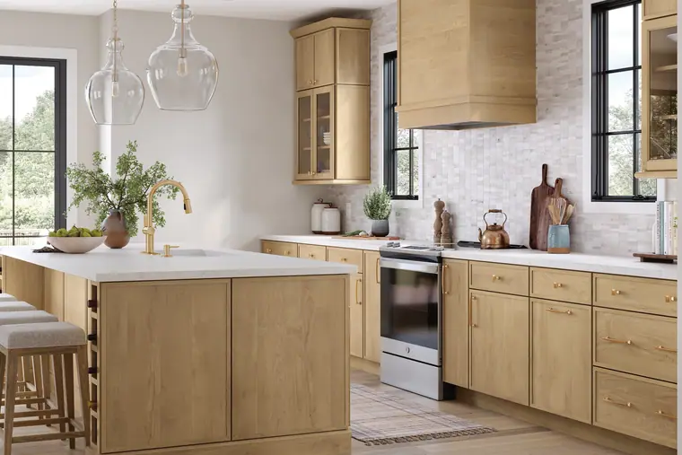 Light-oak kitchen with a wood range hood and black windows