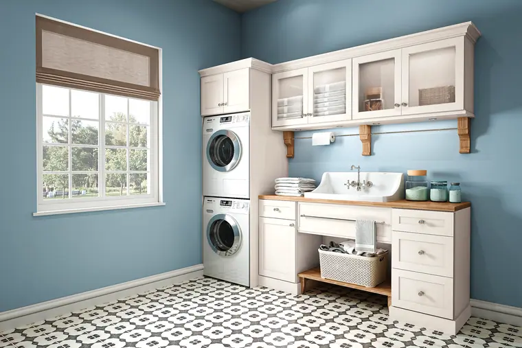 Bright laundry room with white cabinetry and a patterned floor